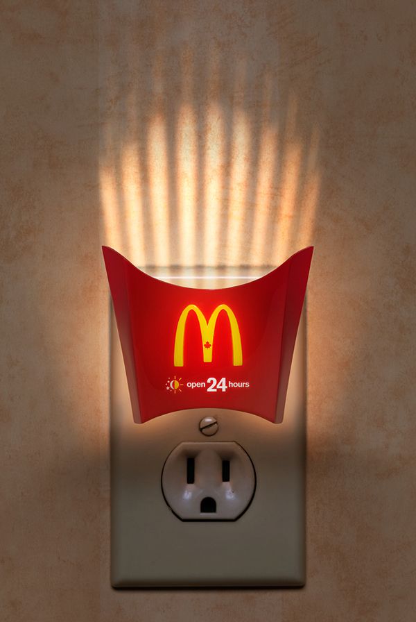 a mcdonald's outlet is lit up with the light coming from behind it,