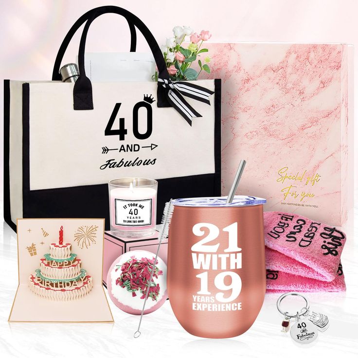 a pink and white gift bag with gifts in it, including a wine tumbler