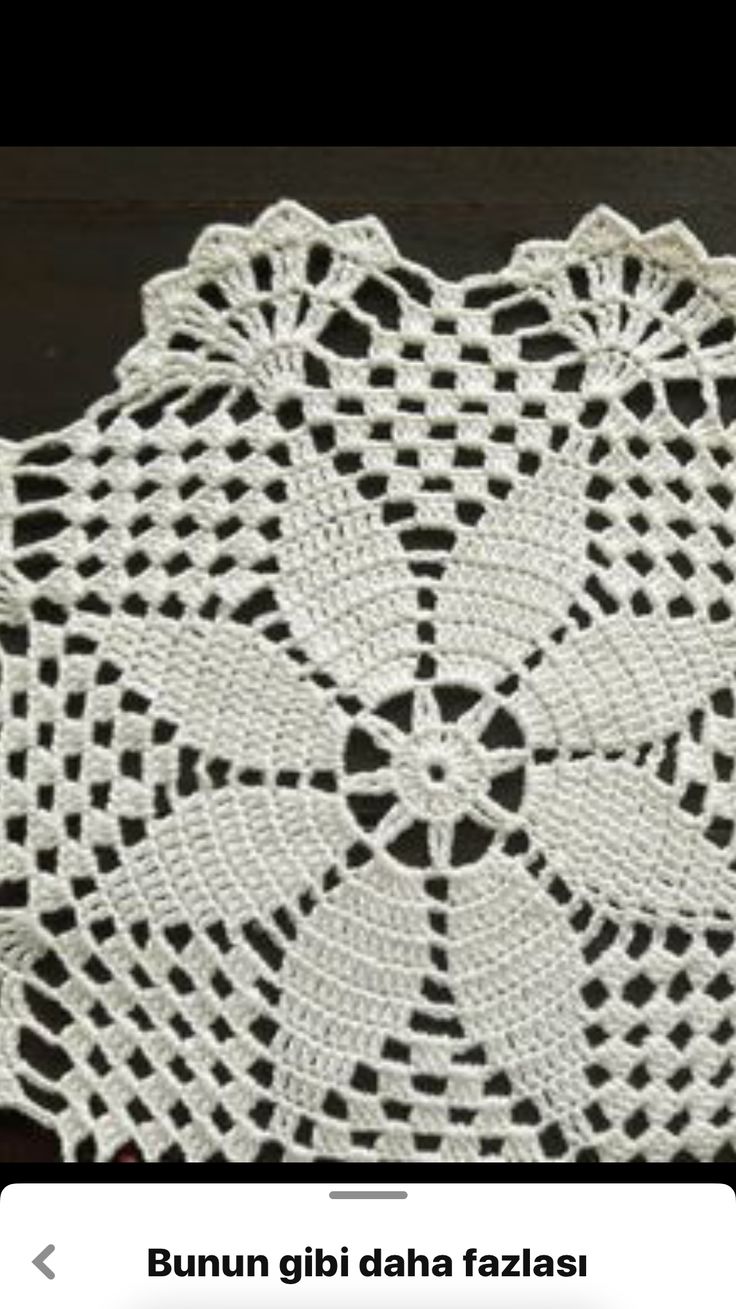 a crocheted doily is shown on a wooden table with the words bunnu gibi daha fazza