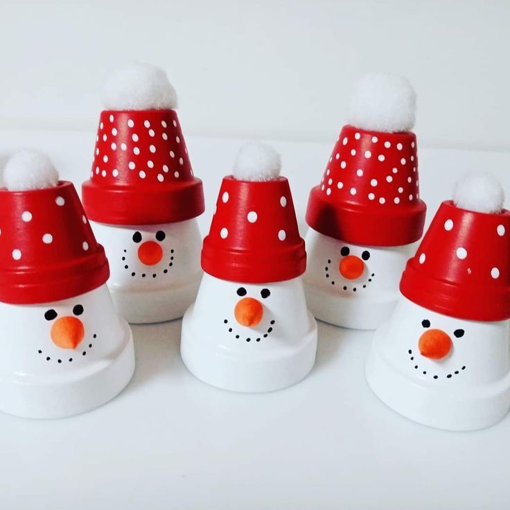 six snowmen with red hats and white dots on them