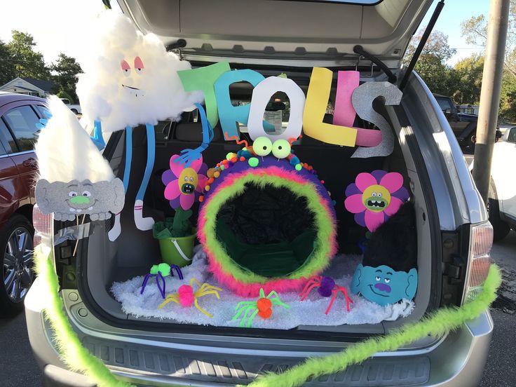 the trunk of a car decorated with letters and decorations