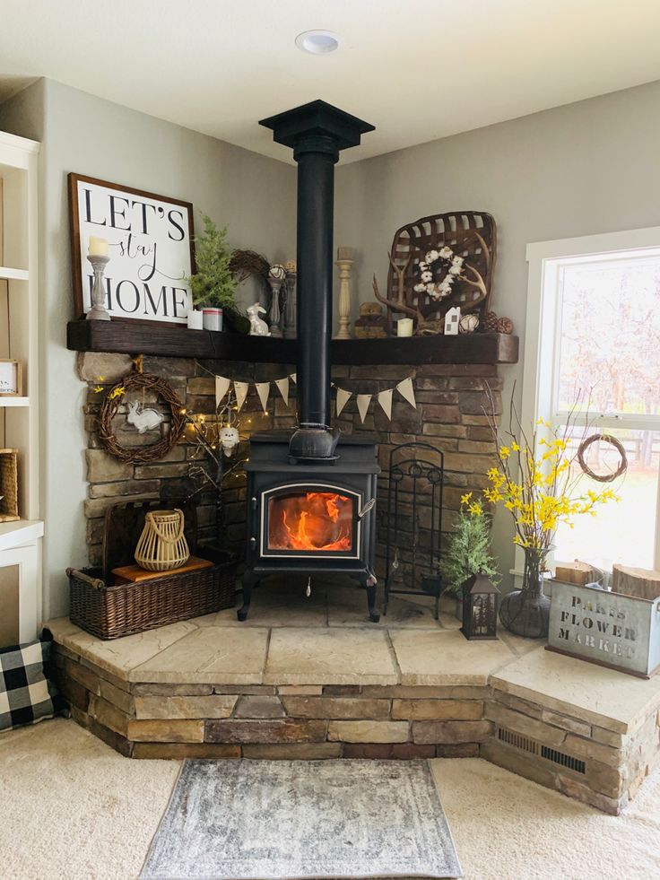 a living room with a fire place in the center and shelves on the wall above it