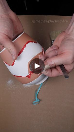 someone is painting an egg with red paint on the inside and white eggs in the middle