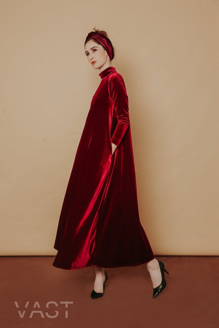 Following the brand's romantic lines and flowing silhouettes, this gown from VAST embodies the brand's elegance thanks to a maxi-style construction in a signature ruby red shade, presents the ultimate in opulence and drama, in a one-tone velvet look. Turtle neckline Long sleeves Flare silhouette Maxi length Loose fit Oversized winter dress Romantic Lines, A Line Long Dress, Baggy Dresses, Maxi Dress Winter, Low Back Dresses, Red Velvet Dress, Velvet Maxi Dress, Velvet Maxi, Frill Dress