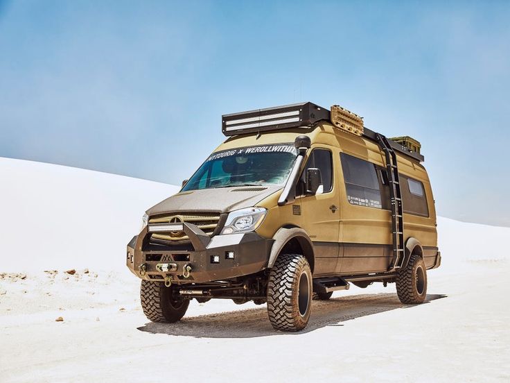 an off - road vehicle is parked in the desert