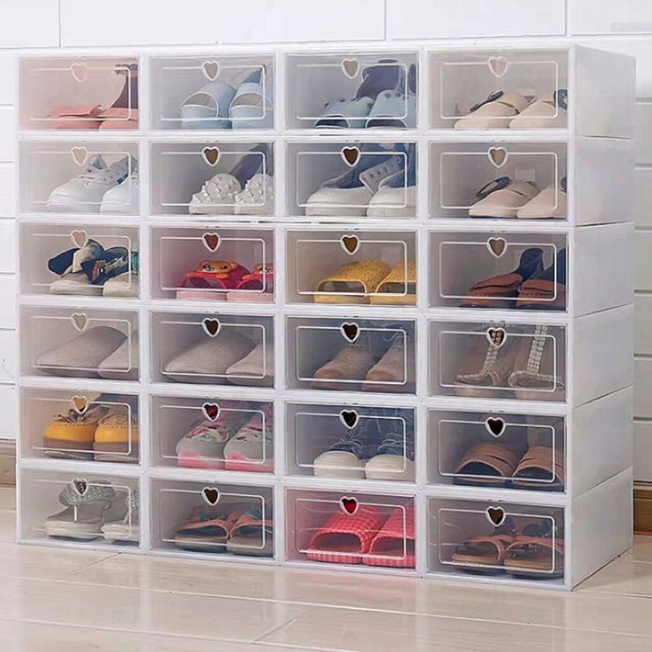 the large storage box is filled with many pairs of shoes and heart shaped holes in it