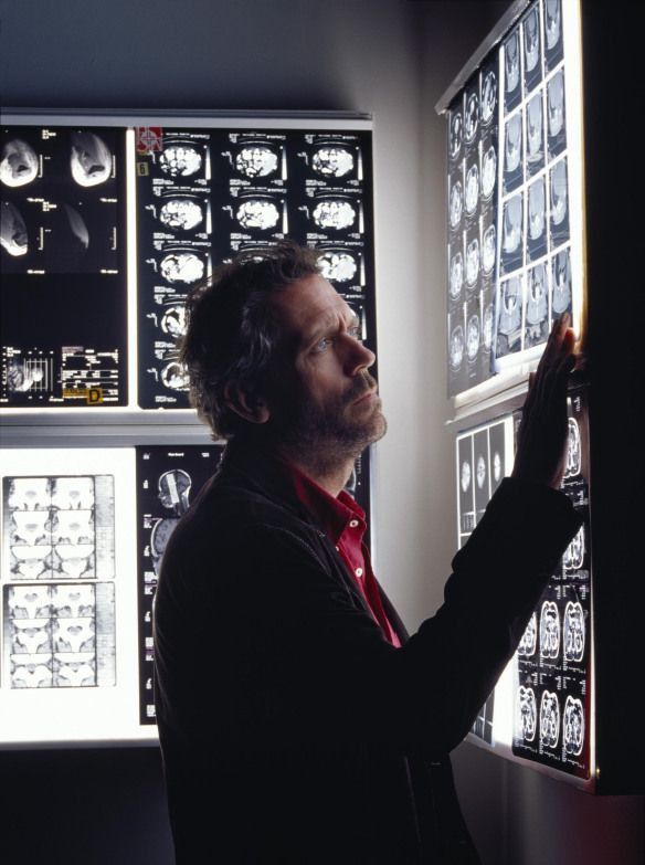 a man standing in front of a display of mri images