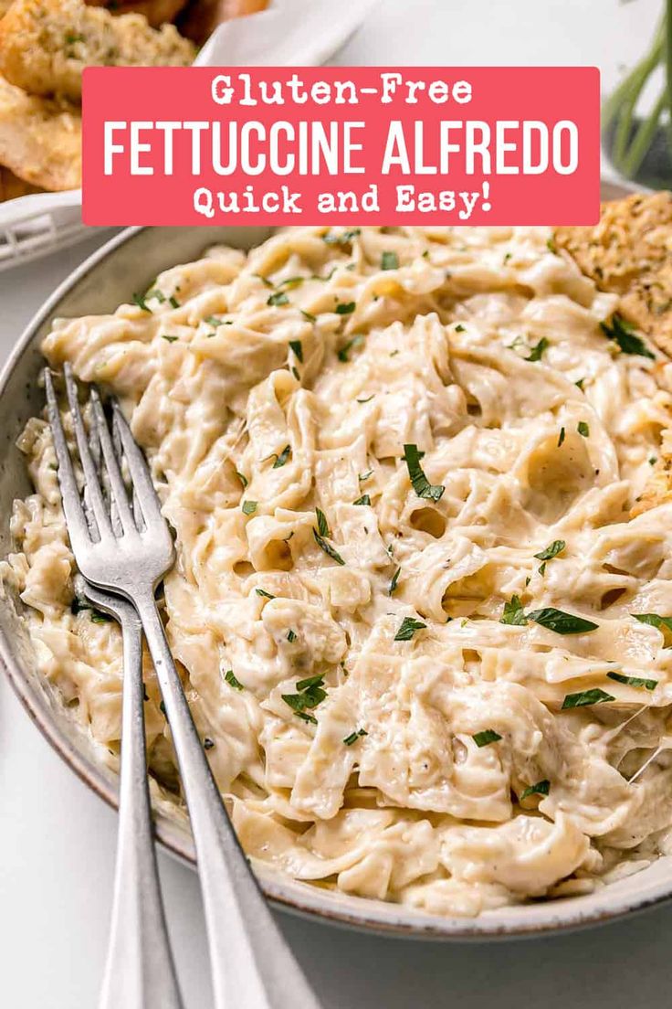 a white plate topped with chicken alfredo next to bread