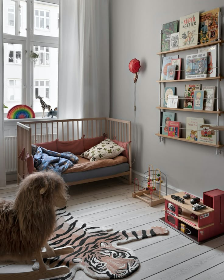 a child's bedroom with a zebra rug and bookshelves on the wall