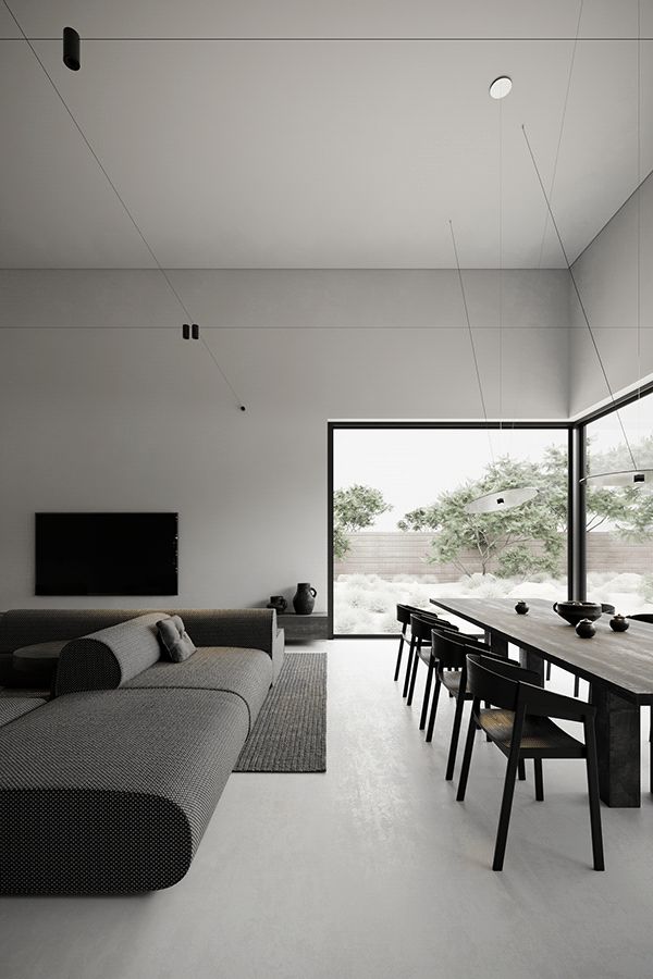 a modern living room with white walls and black furniture