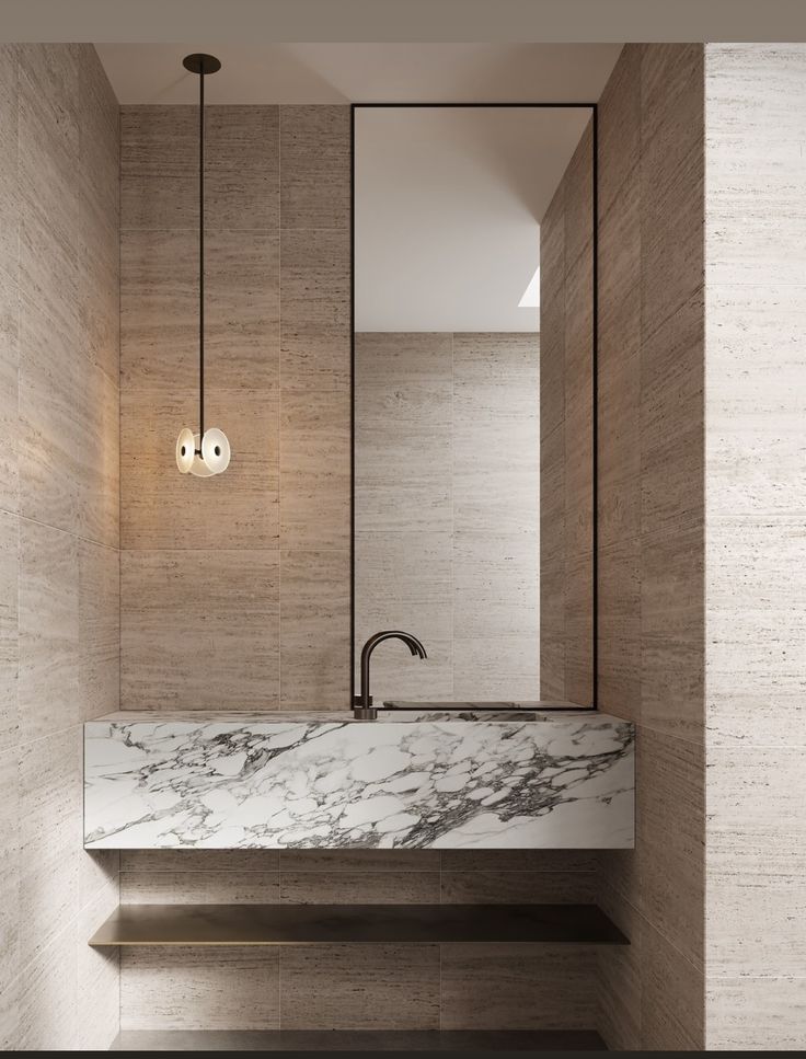 a bathroom with marble counter tops and lights