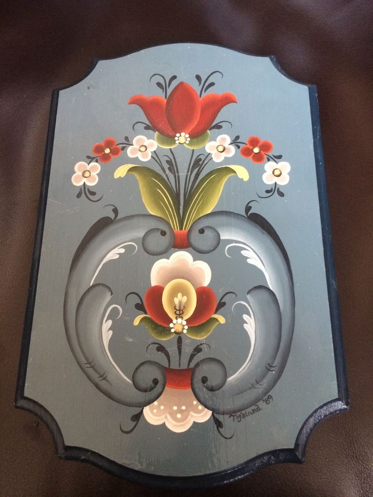 a decorative glass plate with flowers painted on it