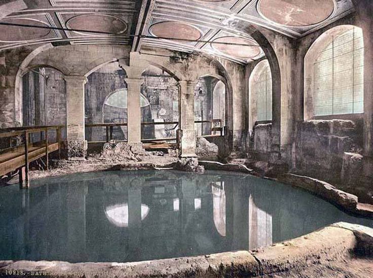 an old abandoned swimming pool in the middle of a room filled with furniture and windows