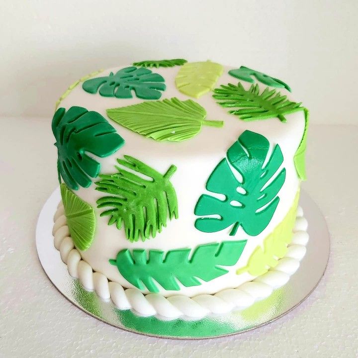 a green and white cake with leaves on it