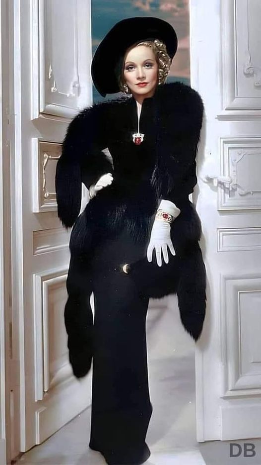 a woman in a black fur coat and hat