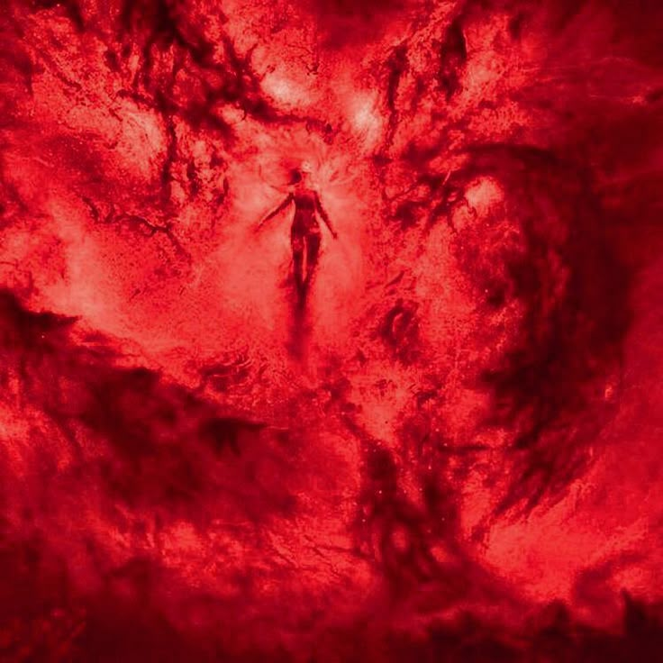 a person is standing in the center of a red cloud like area with black spots