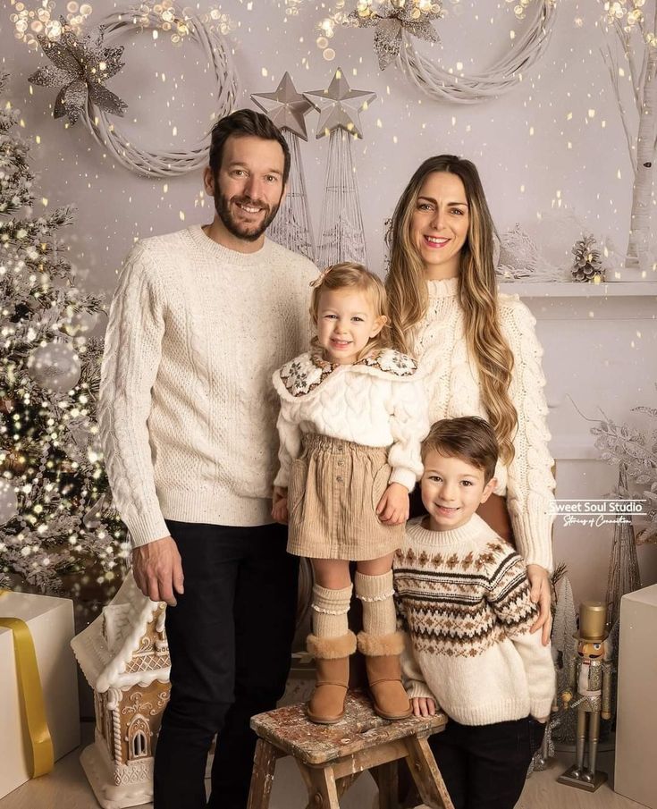 a family posing for a photo in front of a christmas tree