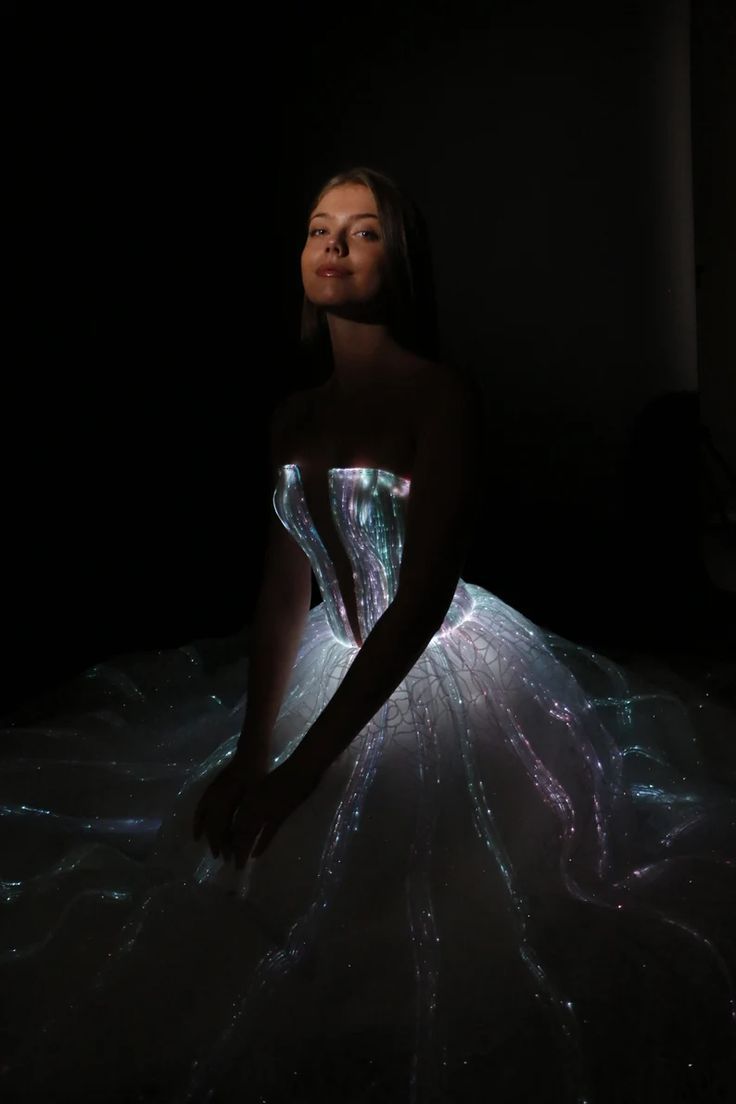 a woman in a dress that is lit up