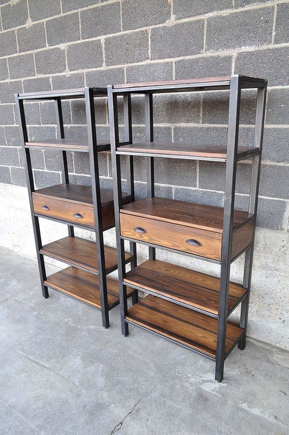 two shelving units with wooden shelves against a brick wall