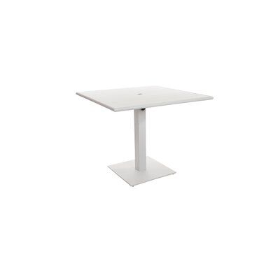 the square table is white and has an extended pedestal on one side, while the other end