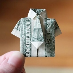 a folded dollar bill in the shape of a man's shirt and bow tie