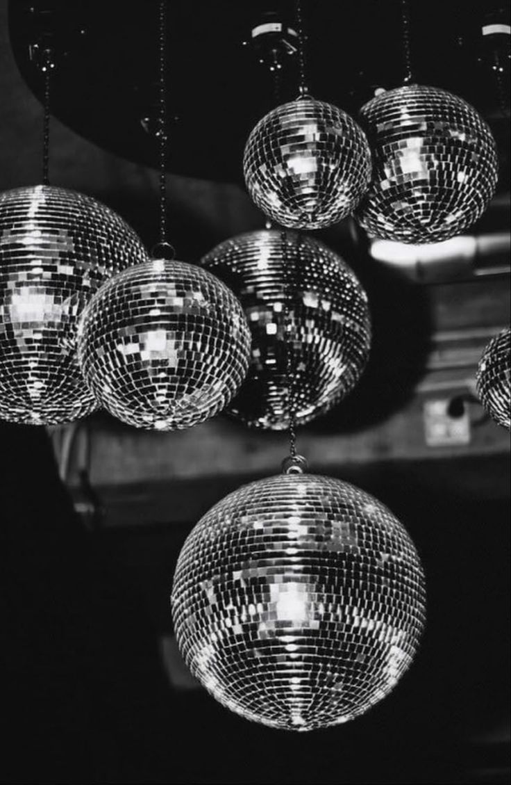 disco balls hanging from the ceiling in black and white