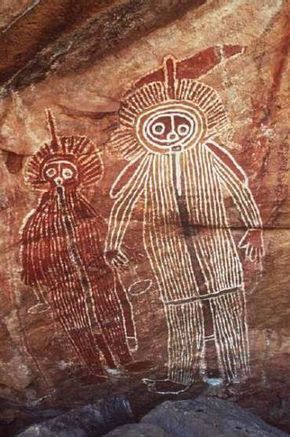 an image of two people painted on the side of a rock