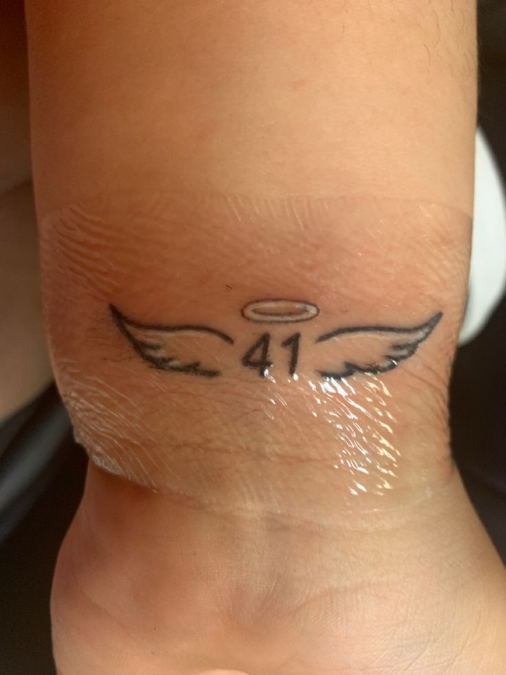 a person with a small tattoo on their foot that has an angel design on it