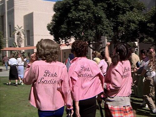 two women in pink shirts are walking together