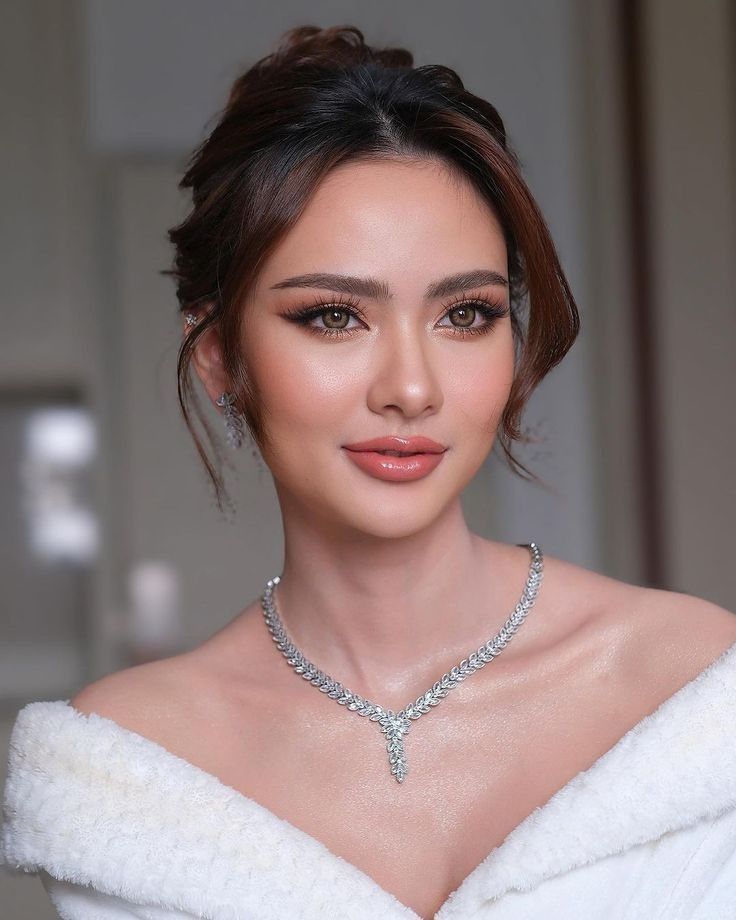 a woman in a white dress wearing a diamond necklace and choker with diamonds on it