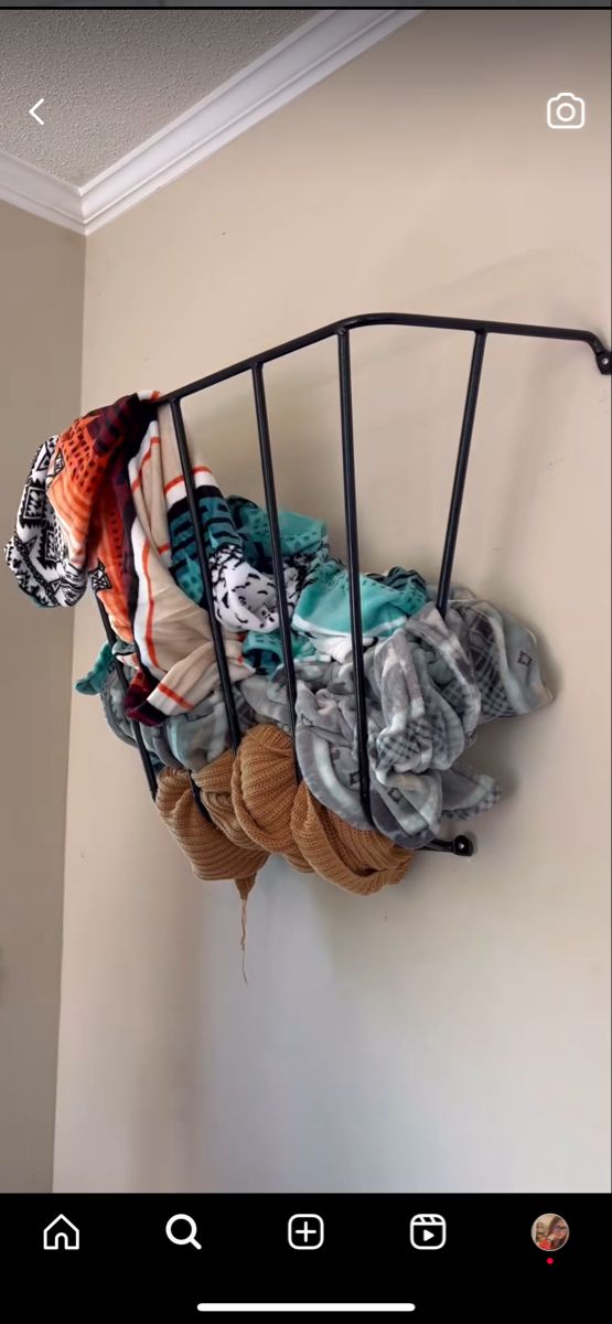 there is a rack with scarves hanging on the wall