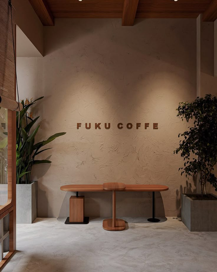 a table and benches in front of a wall with the words fukucoffe on it