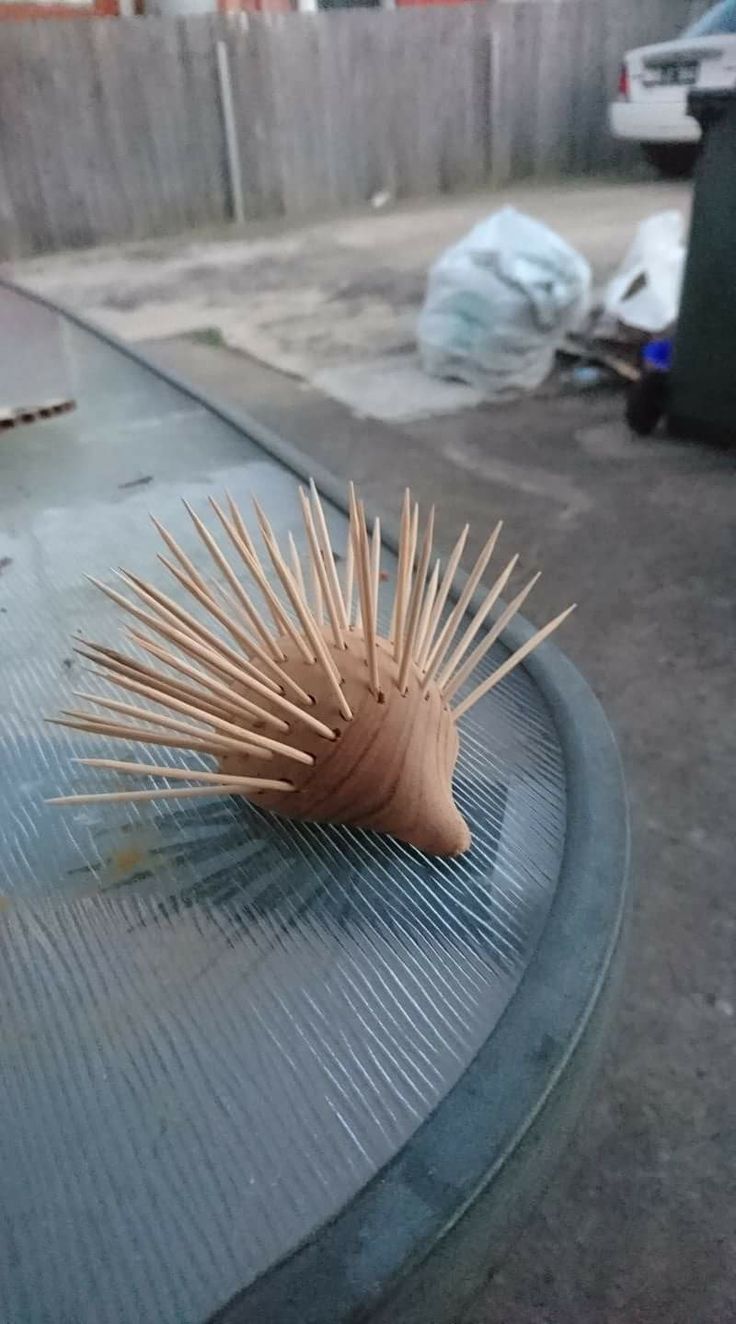 a wooden hedgehog sitting on top of a metal table