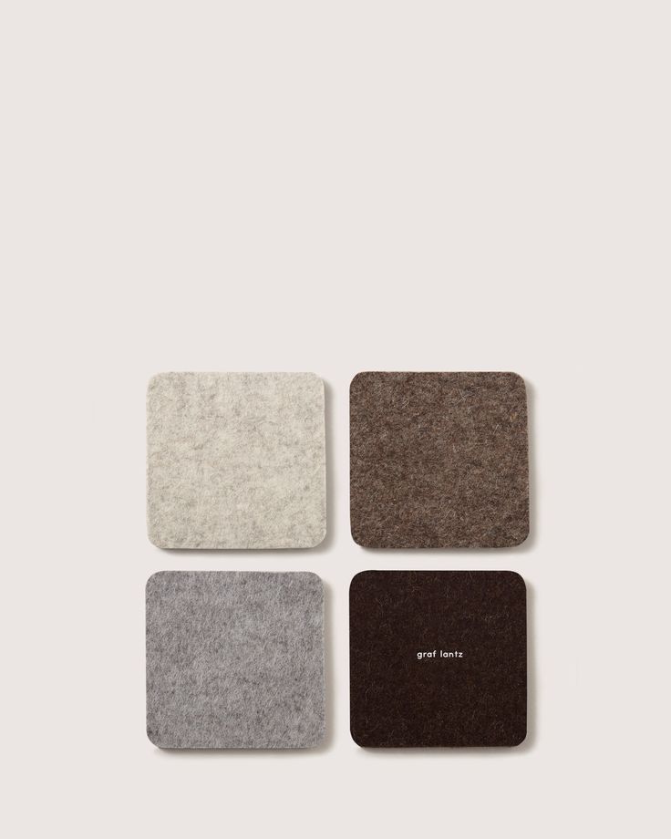 four square coasters in various colors and sizes