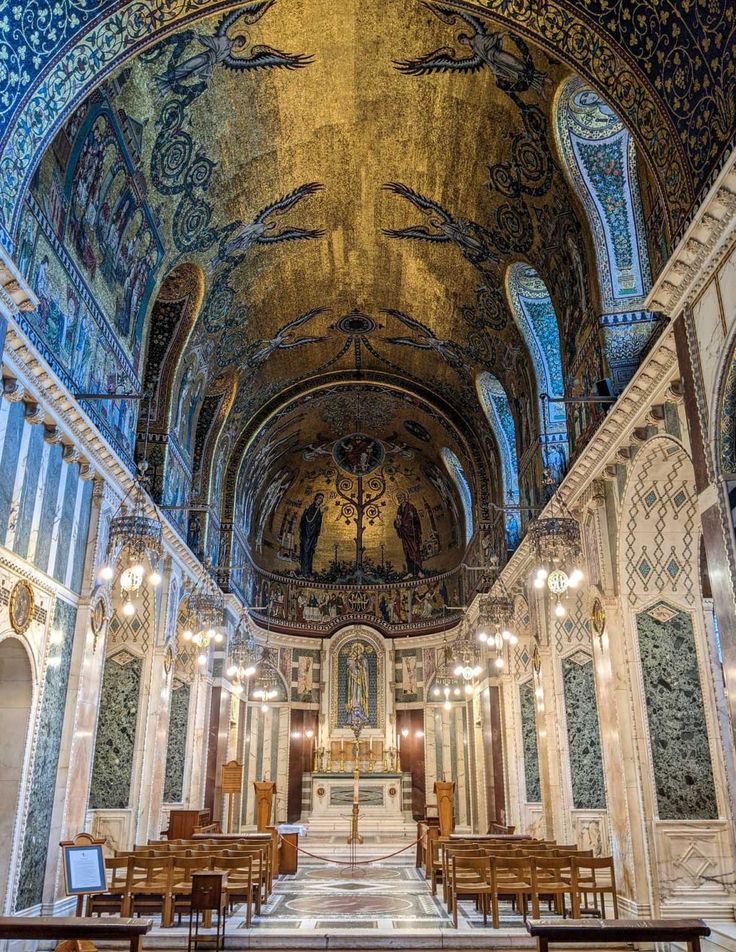 the interior of an old church with pews and stained glass on the ceiling,