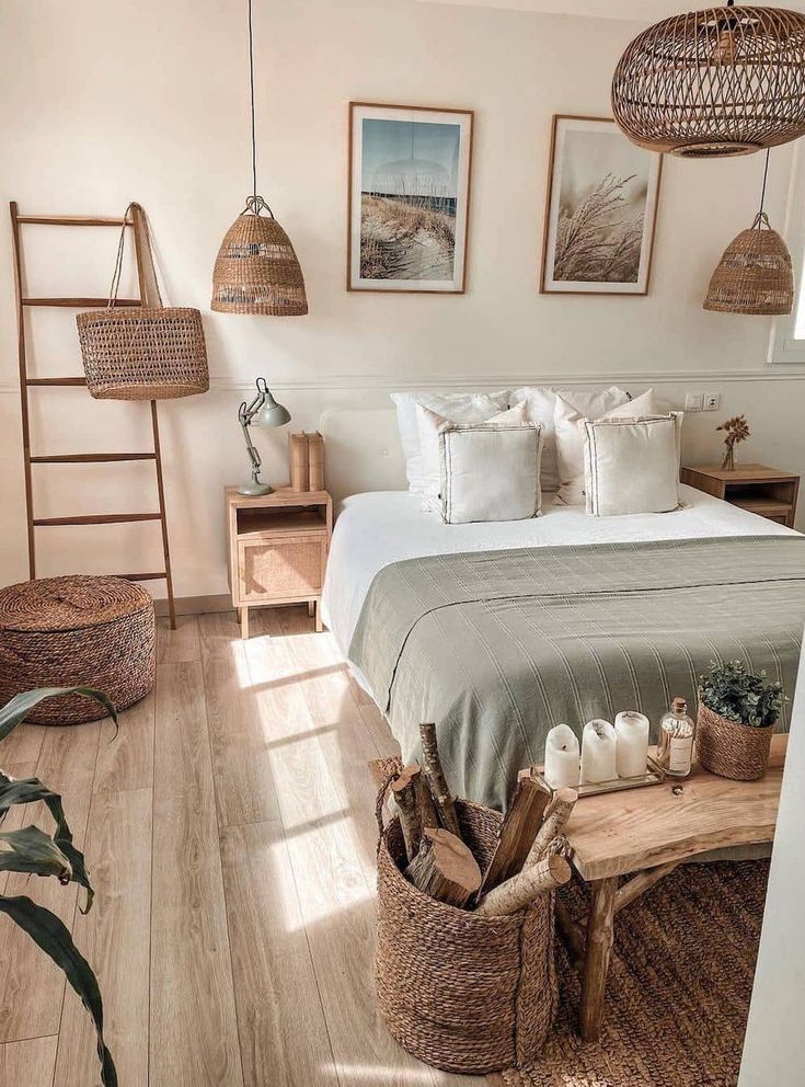 a bed sitting in a bedroom next to a wooden table with baskets on top of it