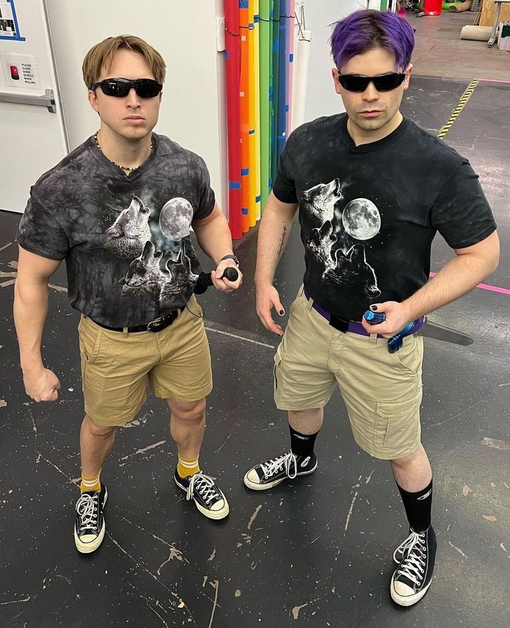 two young men standing next to each other in shorts and t - shirts with the same design on them