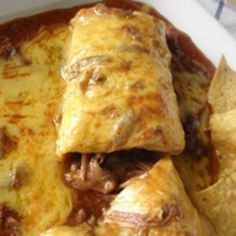 an enchilada with meat, cheese and tortilla chips