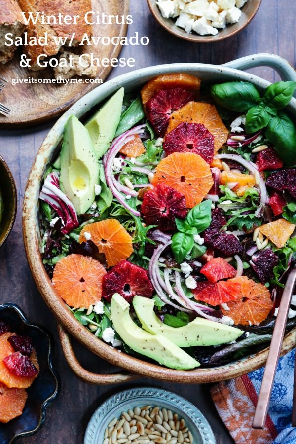 a salad with oranges, avocado and spinach is shown in a bowl