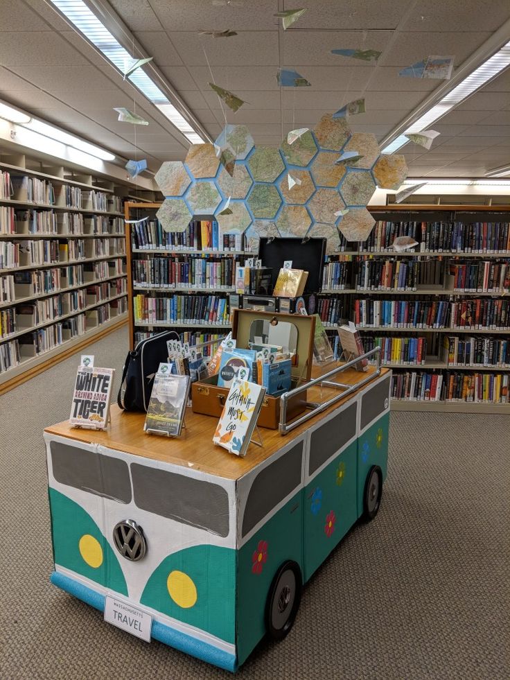 a bus shaped book stand in a library