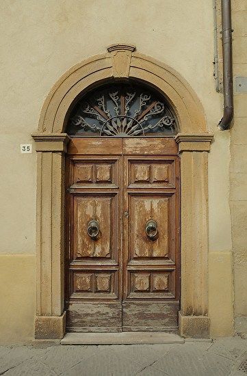 an old wooden door with ornate iron work on it