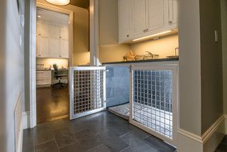 a dog gate in the middle of a kitchen