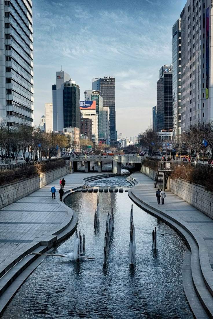 people are walking around in the city with fountains