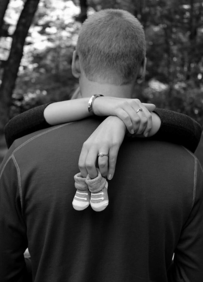 black and white photograph of a man carrying a woman on his back