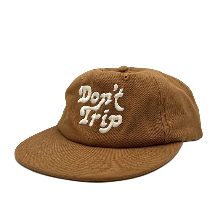 On a white background is a brown unstructured 6 panel baseball hat with white embroidery that reads, Don't Trip. Trendy Cotton Baseball Cap For Vacation, Summer Snapback Baseball Cap In Canvas, Summer Canvas Snapback Baseball Cap, Trendy Cotton Snapback Hat For Beach, Summer Trucker Hat With Flat Bill For Travel, Summer Travel Trucker Hat With Flat Bill, Summer Canvas Snapback Hat, Summer Flat Bill Trucker Hat For Travel, Cotton Snapback Beach Hat