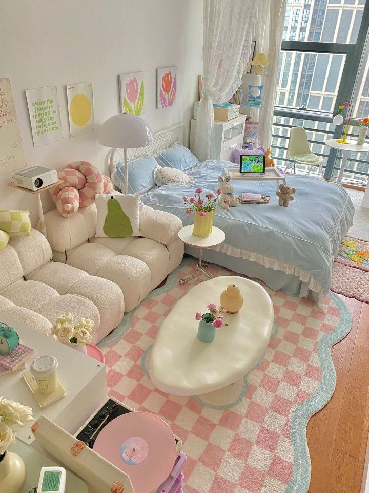 a living room filled with white furniture and lots of pink flowers on the floor next to a window