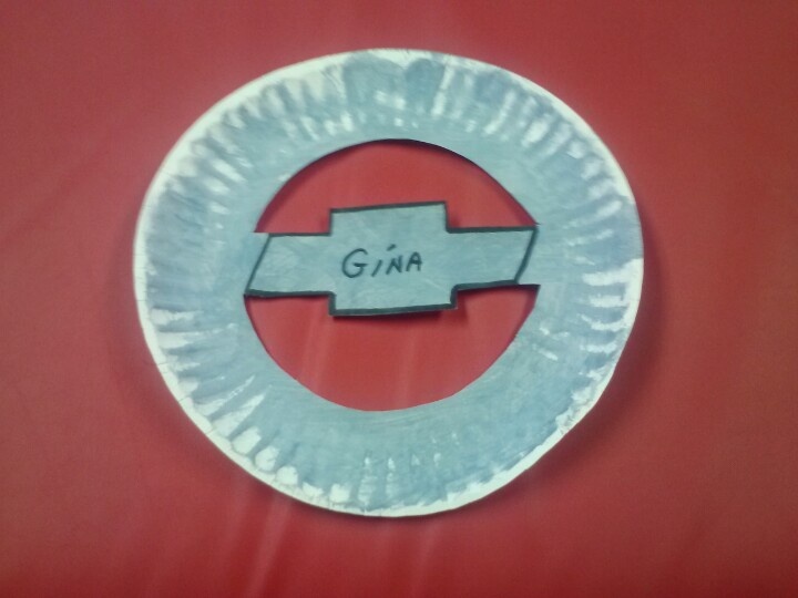 a paper plate with the word gina on it and a car emblem in the middle