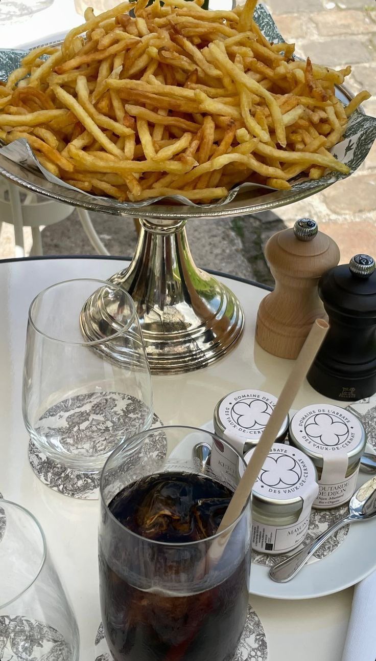 french fries on a table next to wine glasses