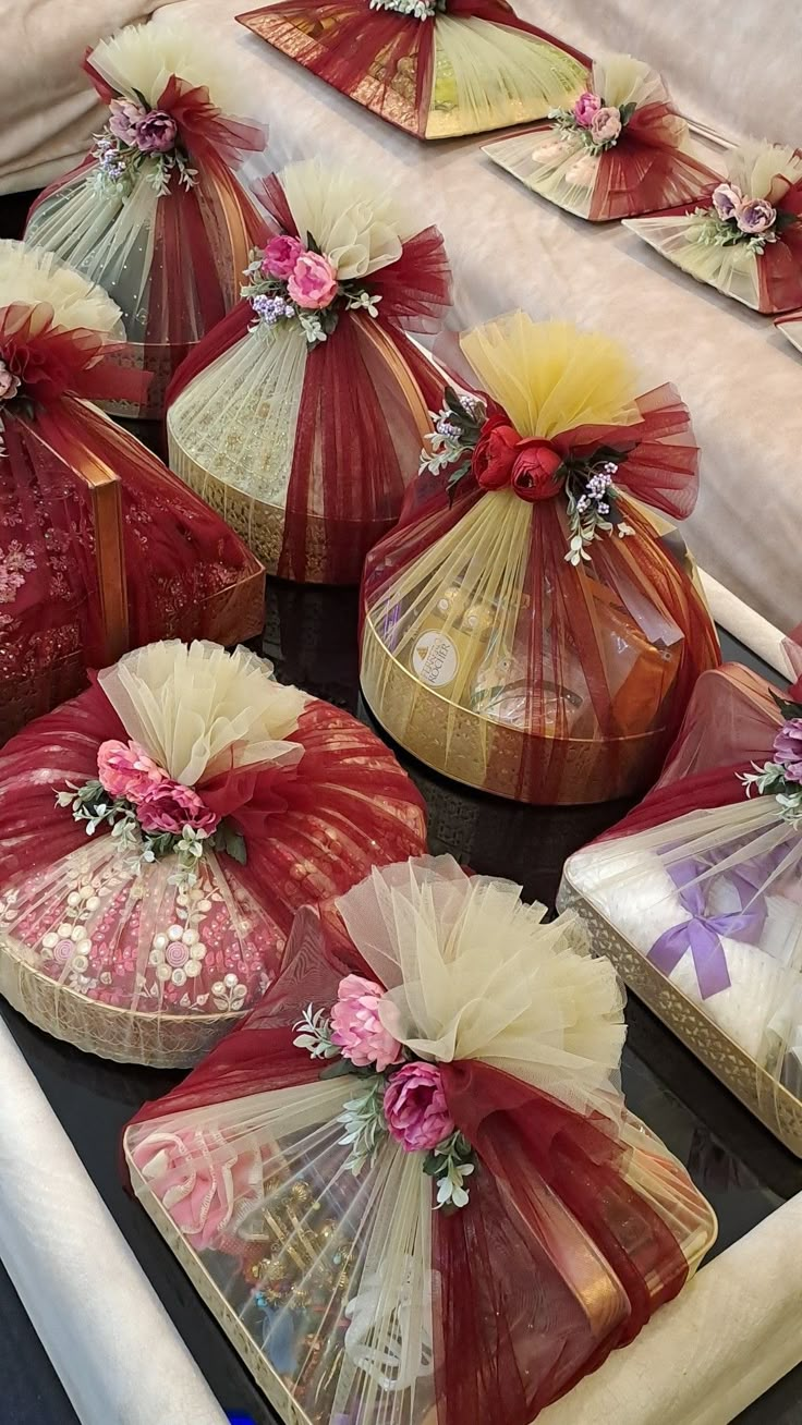 several baskets with flowers and ribbons on them