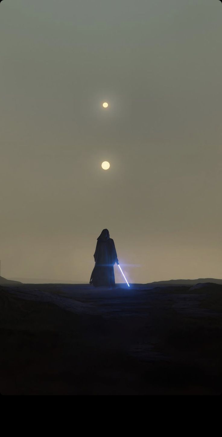 a person standing in the middle of a field holding a light saber